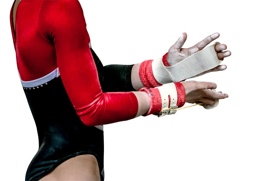 Gymnast with hand grips and chalk - a potent combination for grip safety and security.