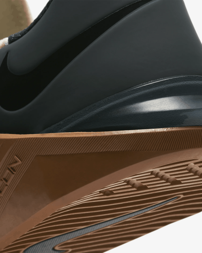 Heel closeup of the Nike Metcon 5 Cross Trainer for CrossFit in Pale Ivory/Seaweed/Light British Tan/Black