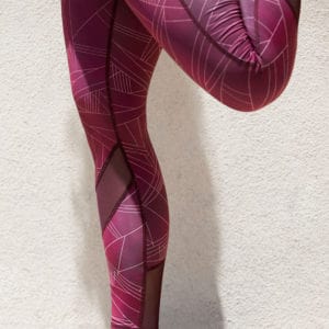Quad stretch of the Hylete Motiv II Vent Workout Tights in Galaxy Plum