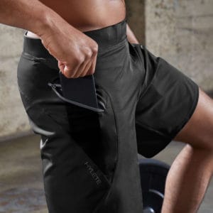Phone in the pocket of the Hylete Men's Workout Shorts for CrossFit - the Verge II in Black/Black