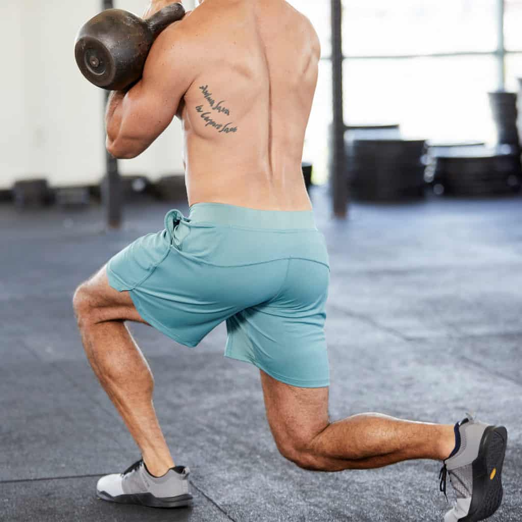 Kettlebell lunge with the Fuse Men's Workout Shorts for CrossFit from Hylete in Heather Trellis/Trellis color
