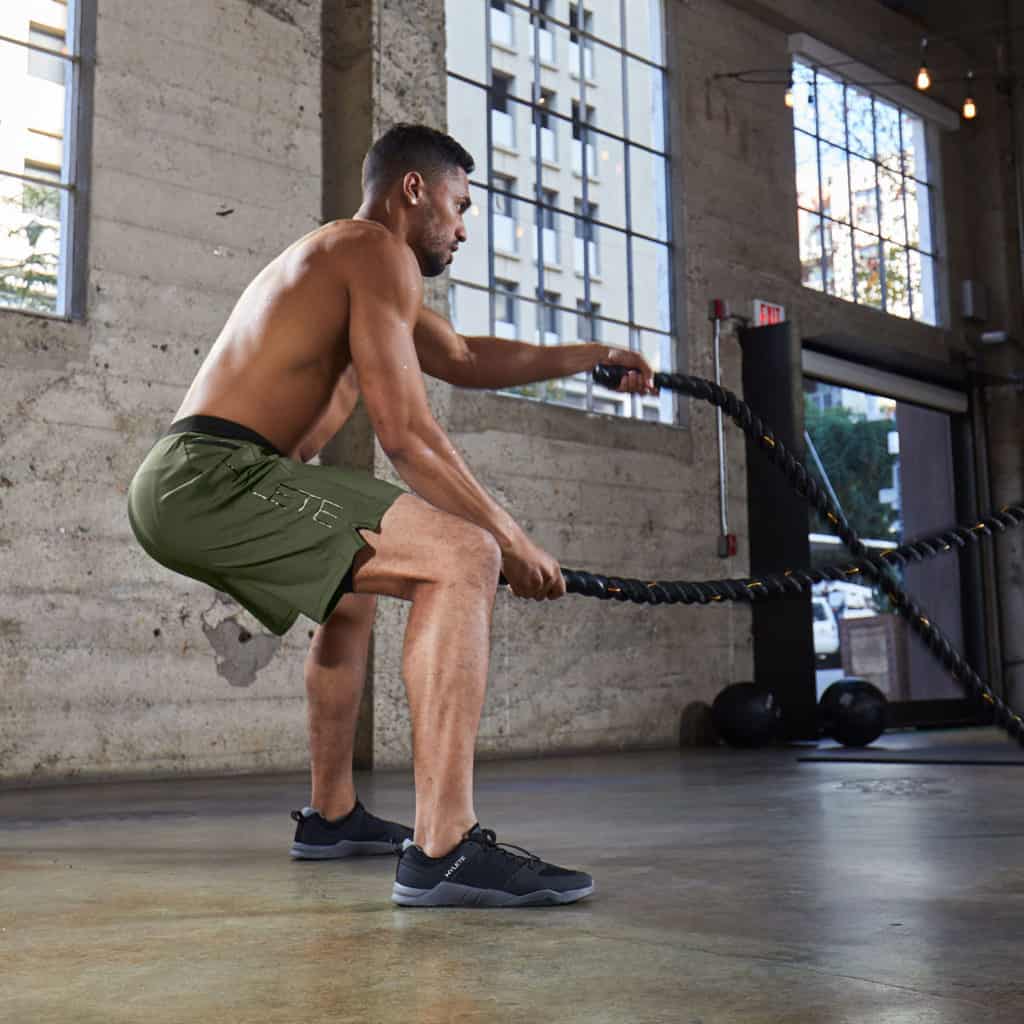 Battle ropes with the Men's workout shorts from Hylete - Vertex II - Olive