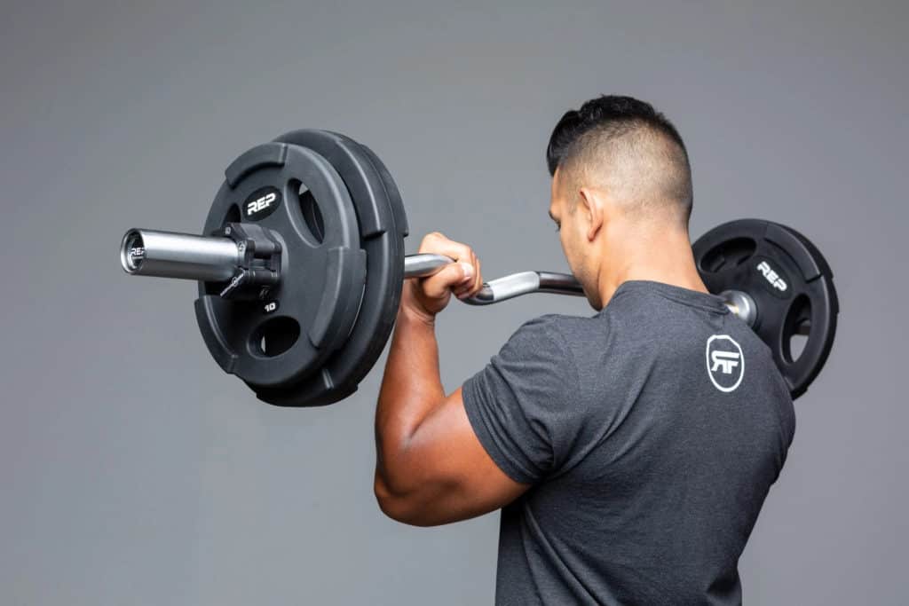 Rep Fitness EZ Curl Barbell with a user