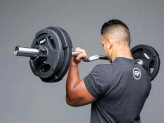 Rep Fitness EZ Curl Barbell with a user