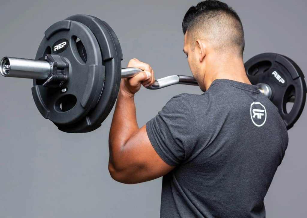 Rep Fitness EZ Curl Barbell with a user