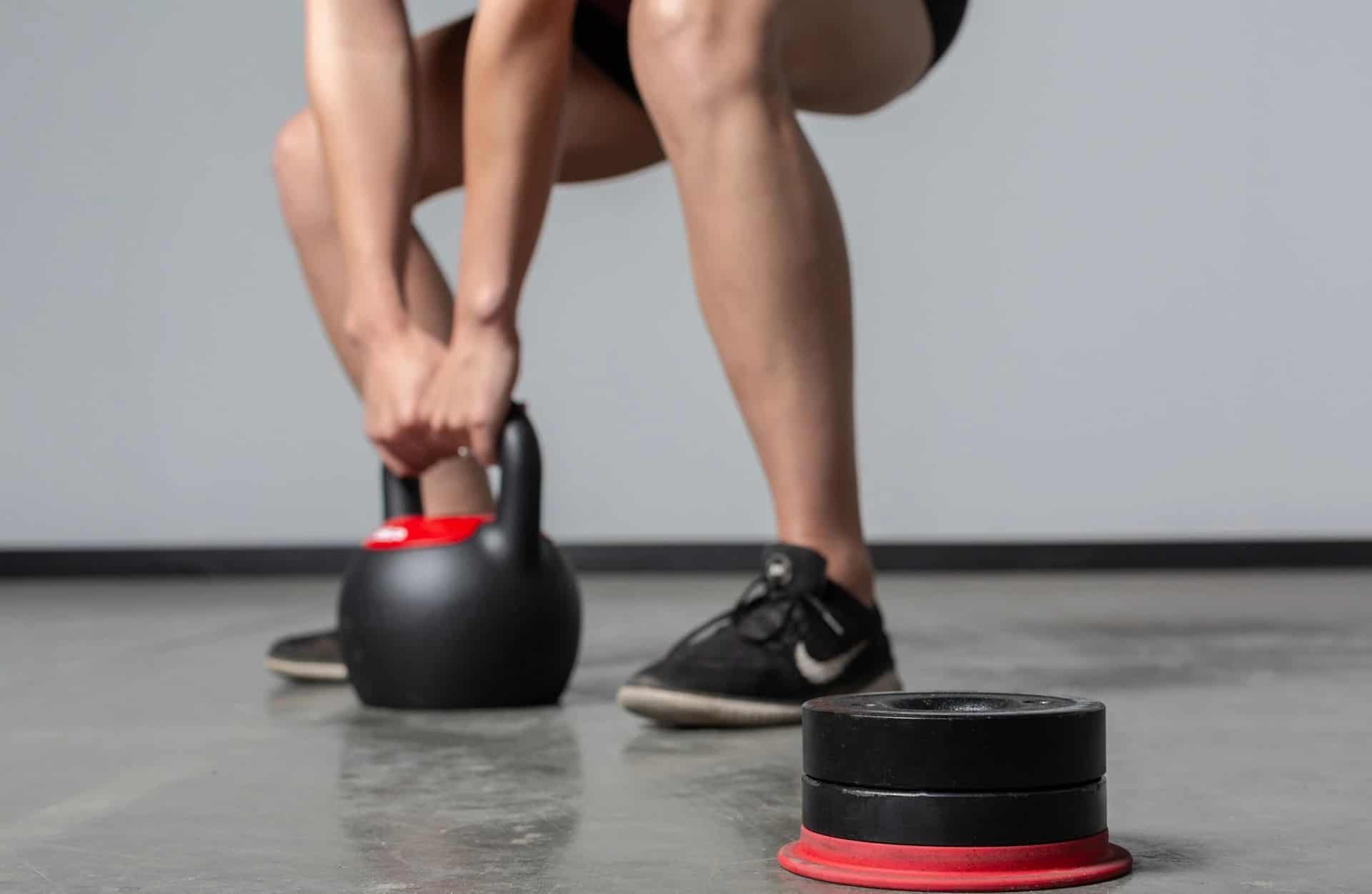 Rep Fitness Adjustable Kettlebell with a user 4