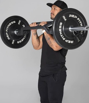 Rep Fitness Cambered Swiss Bar with a user 5