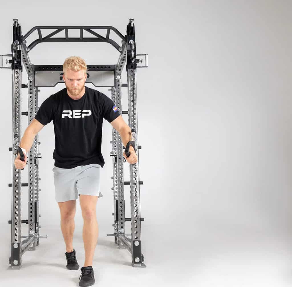 Rep Fitness Athena Selectorized Side-Mount Functional Trainer with an athlete