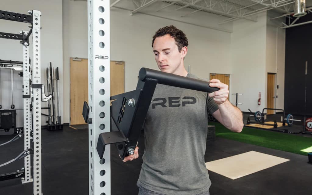 Rep Fitness Drop-In Dip Attachment for PR-4000 and PR-5000 Racks with an athlete 3