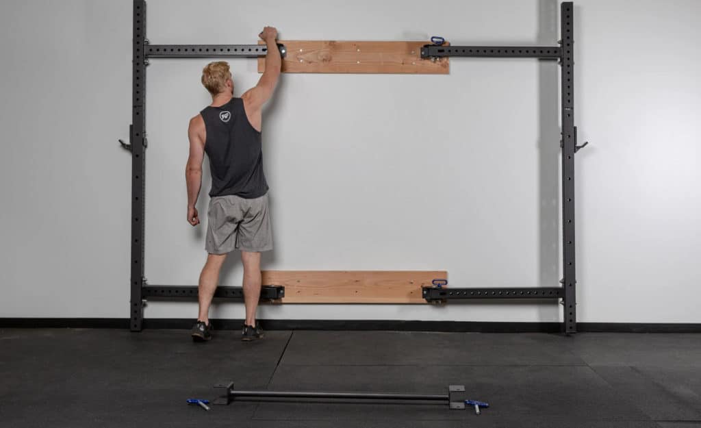 Rep Fitness PR-4100 Folding Squat Rack with an athlete