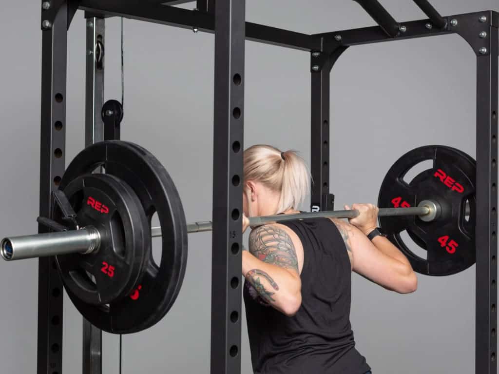 Rep Fitness Rubber Coated Olympic Plates with an athlete 4